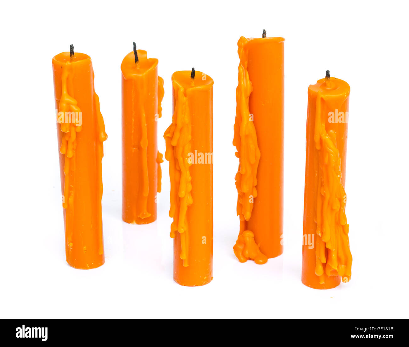 Yellow candle with candle drippings on white background Stock Photo Alamy