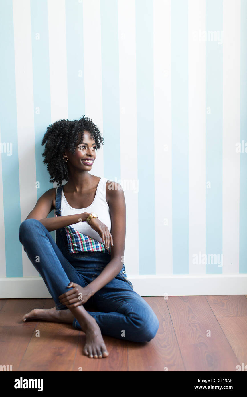 Young black woman in the room on the floor Stock Photo - Alamy