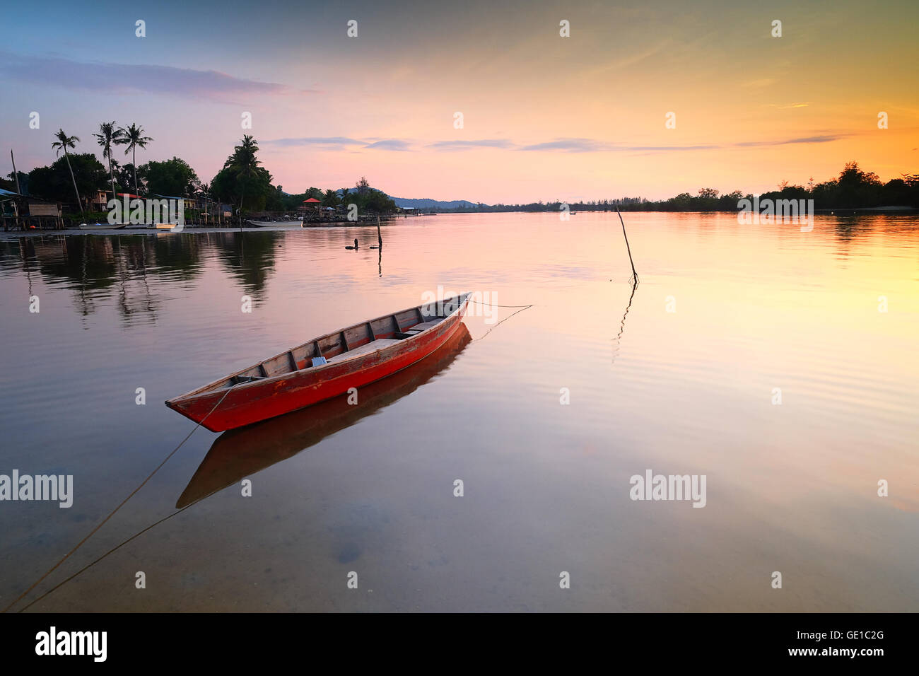 Boat anchored on the beach at sunset, Tuaran, Sabah, Malaysia Stock Photo