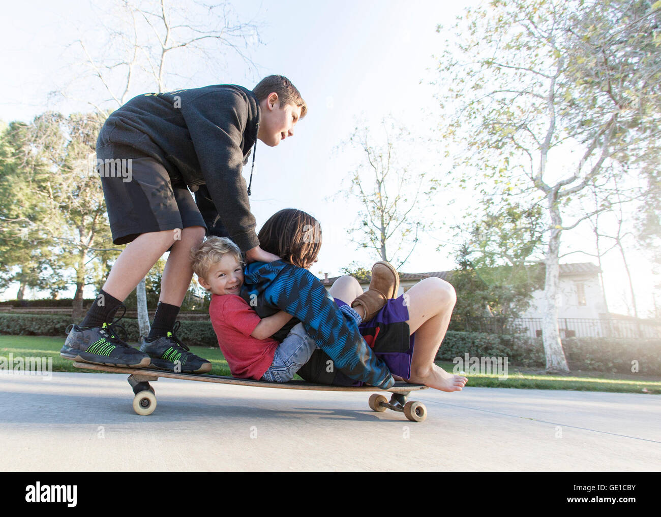 Three boys skateboarding Stock Photo