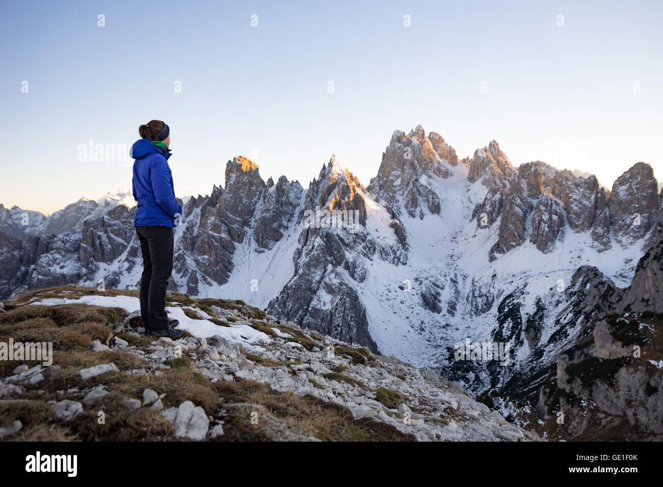 Woman standing in the Dolomite Mountains looking at view, South Tyrol, Italy Stock Photo