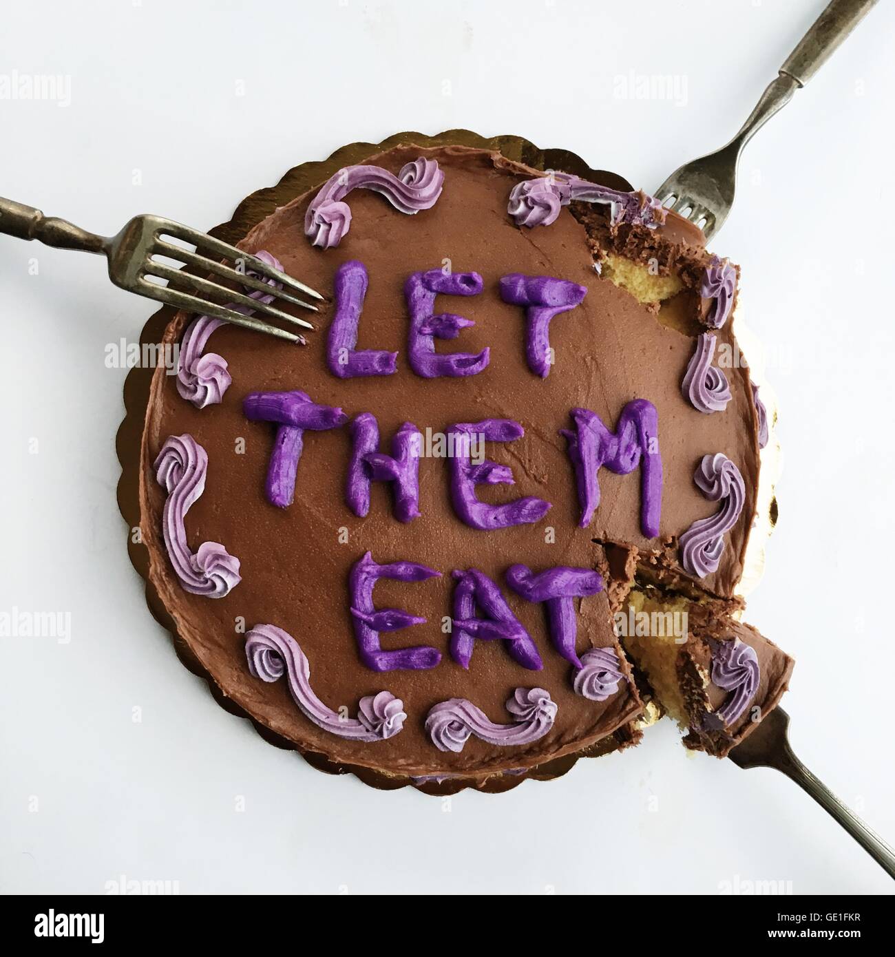 Chocolate cake with Let them eat cake message Stock Photo