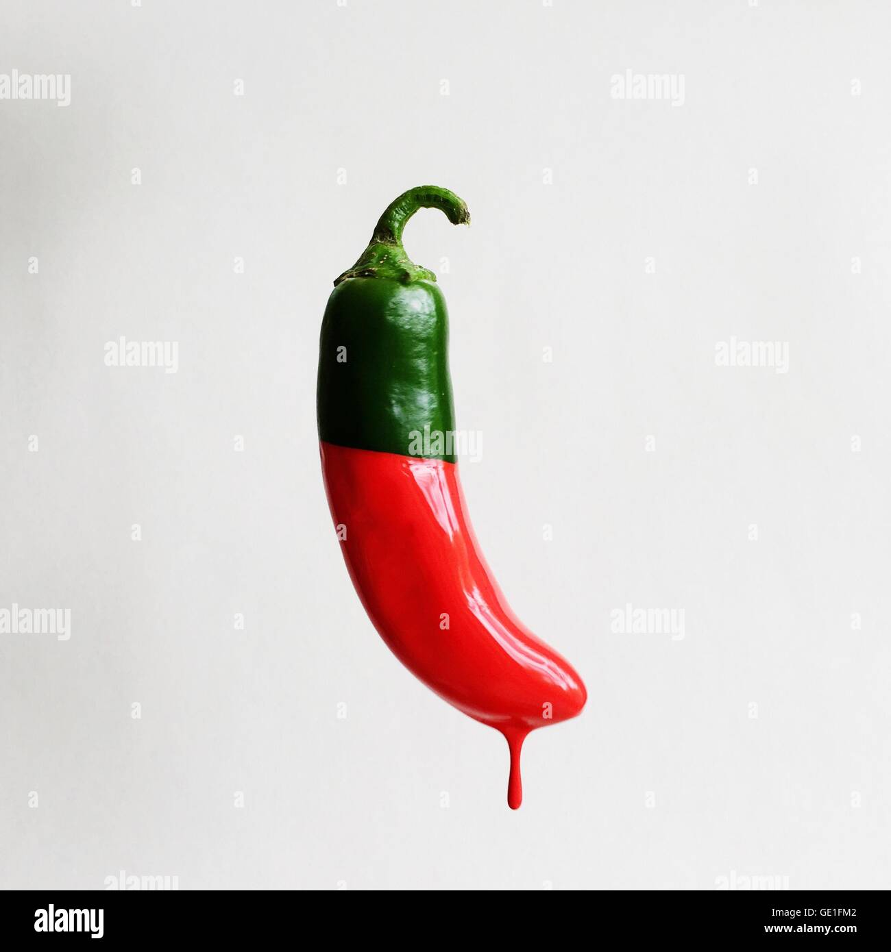 Green chill dipped in red paint Stock Photo