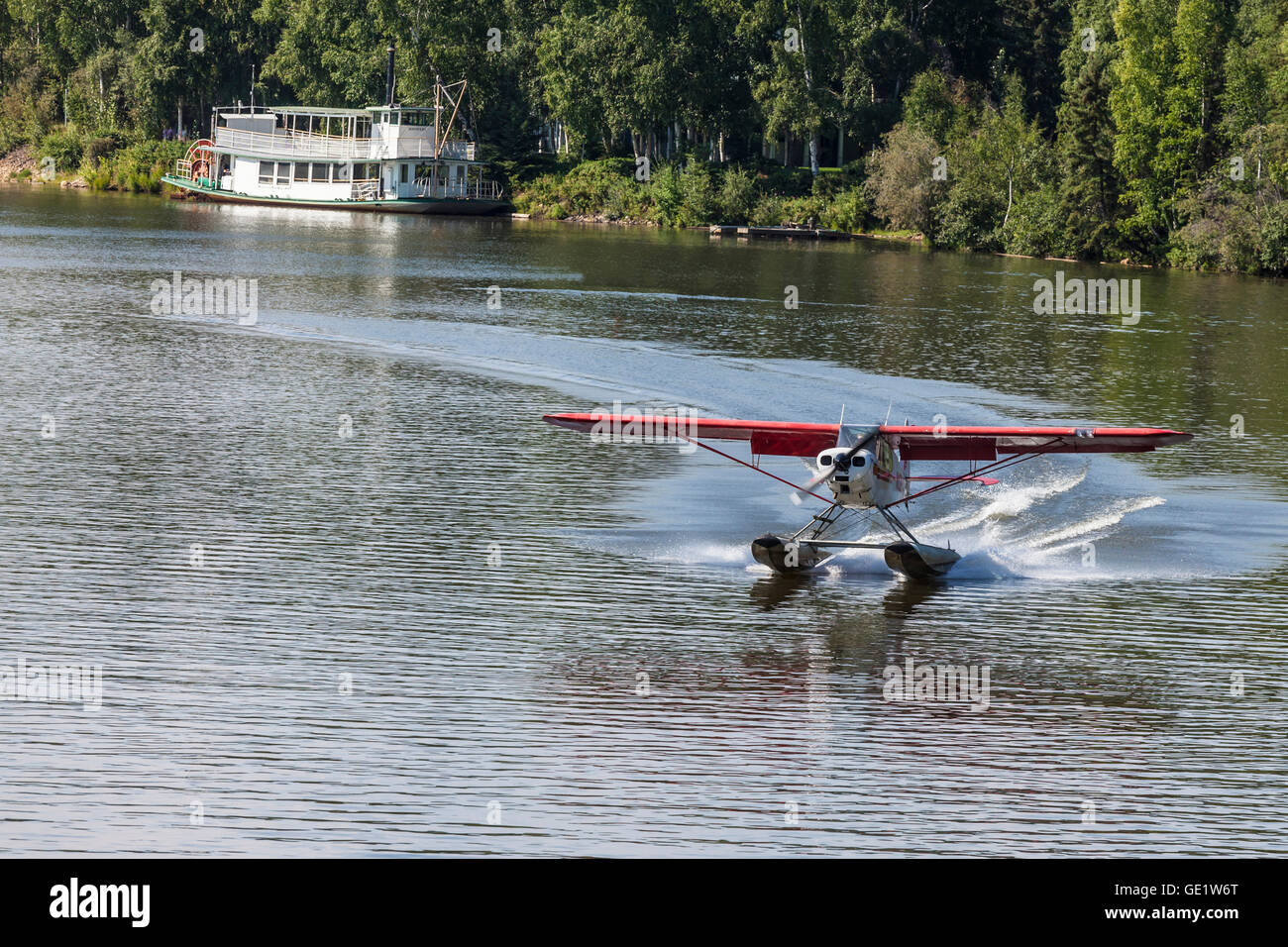 Float plane landing on Chena River at Fairbanks AK Stock Photo