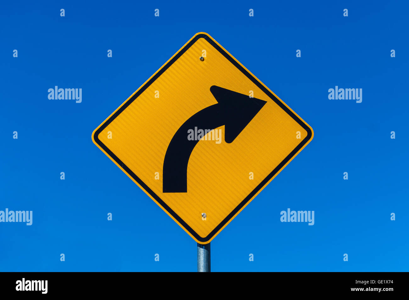 Warning road sign right hand bend Stock Photo