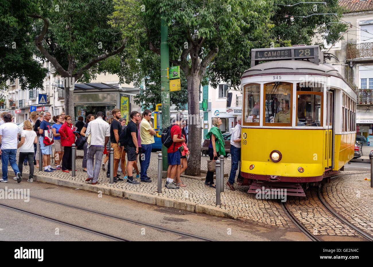 Lisbon, Portugal - September 19, 2014: People waiting at the tram stop. Tram is the symbol of the city. Stock Photo
