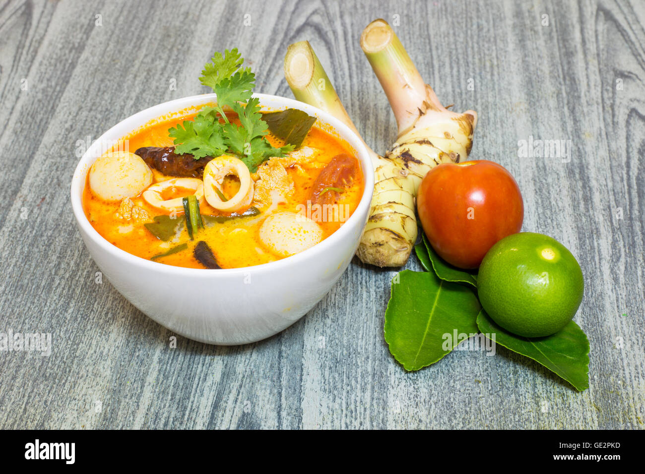 Tom Yum Kung-Thai spicy soup with Herb set of Tom Yum Soup Ingredients on wood background Stock Photo