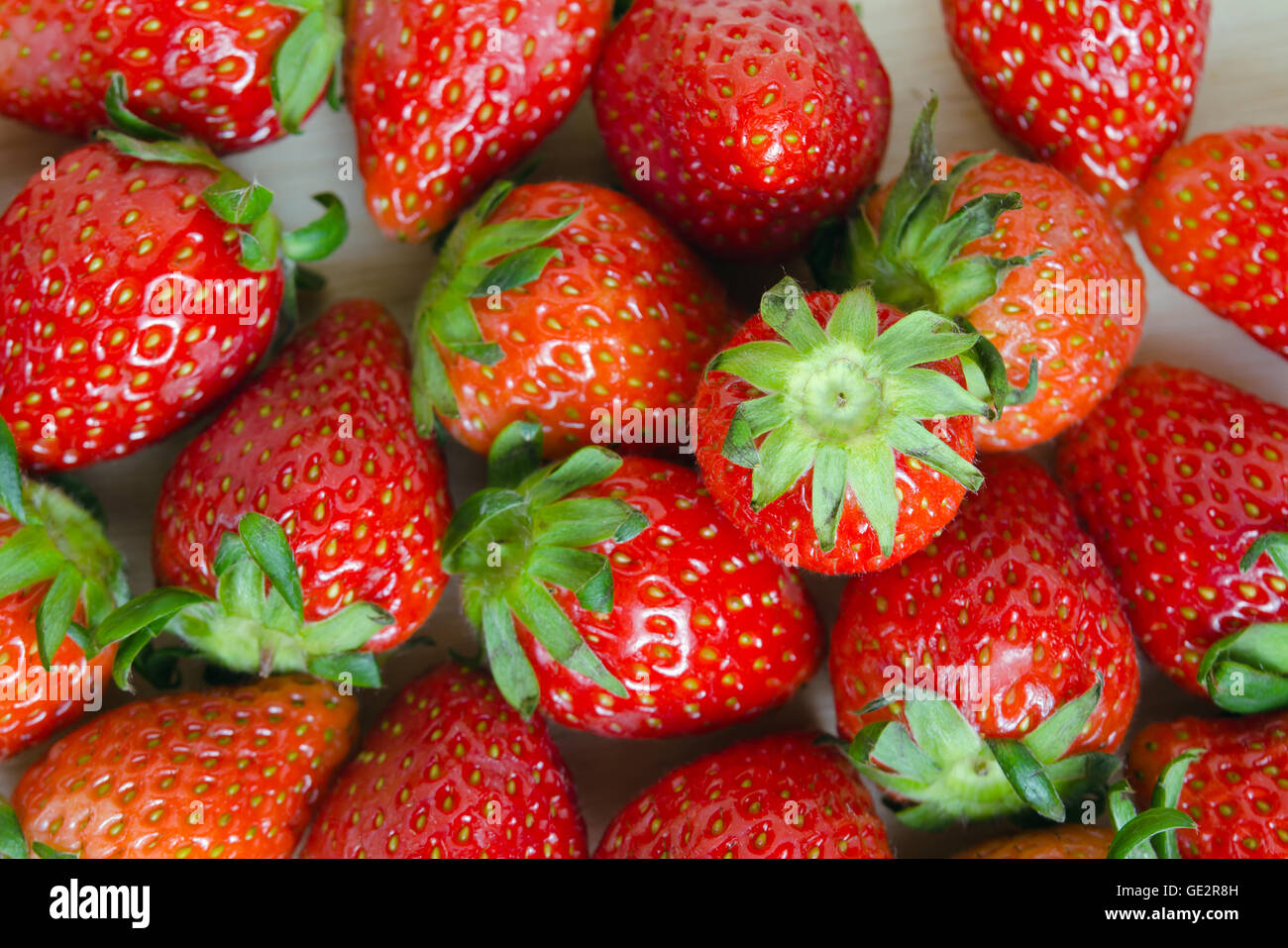 Group of red ripe strawberry over wooden board background Stock Photo ...