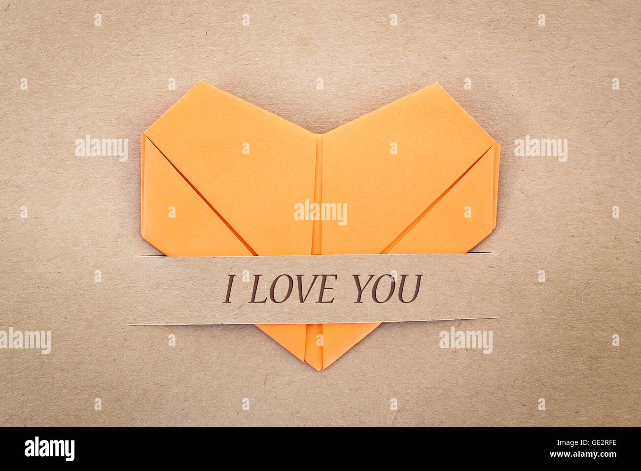 Valentine card, The heart shape paper on brown with 'I love you' label Stock Photo