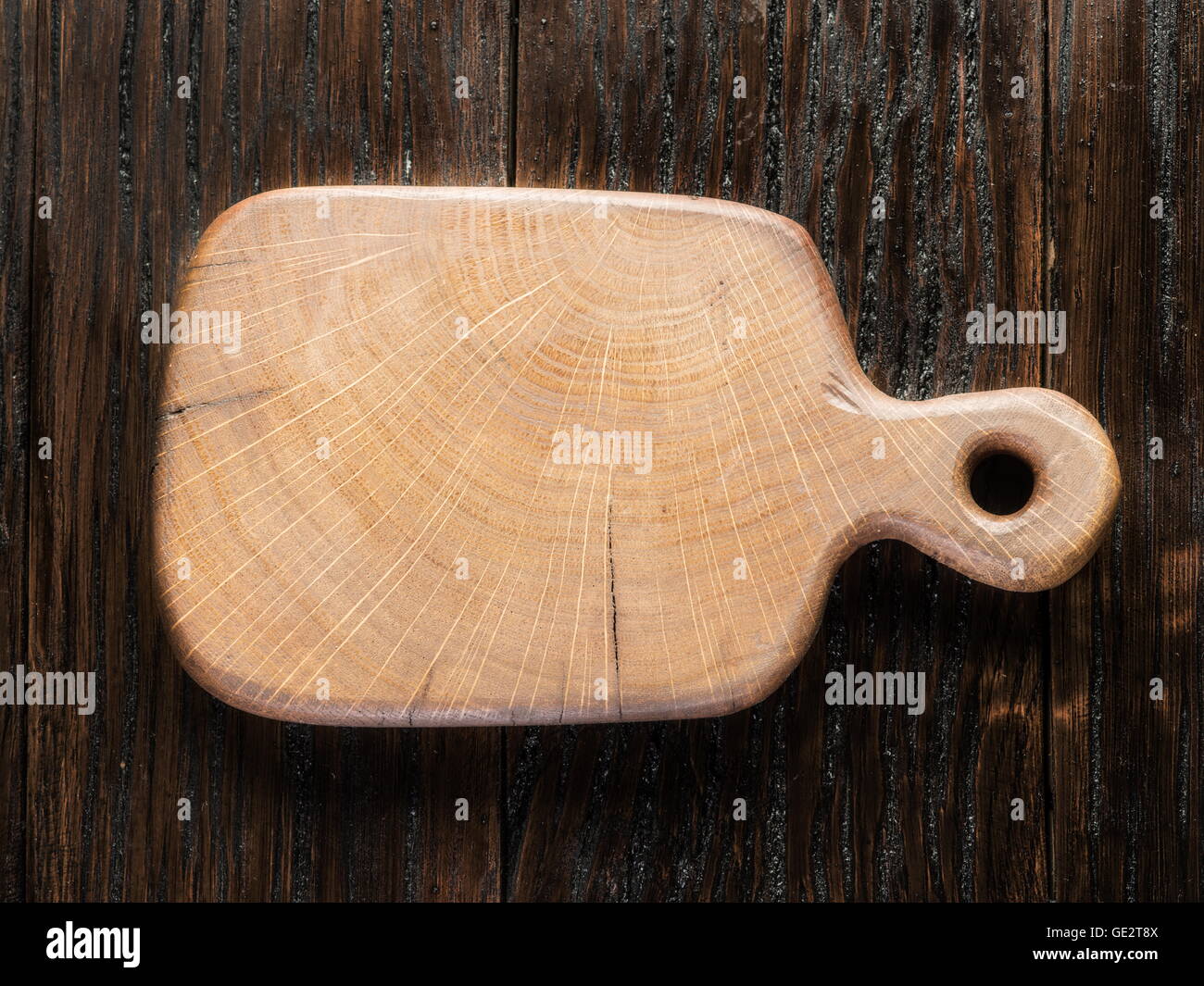 Empty chopping wooden board on the wooden table. Stock Photo