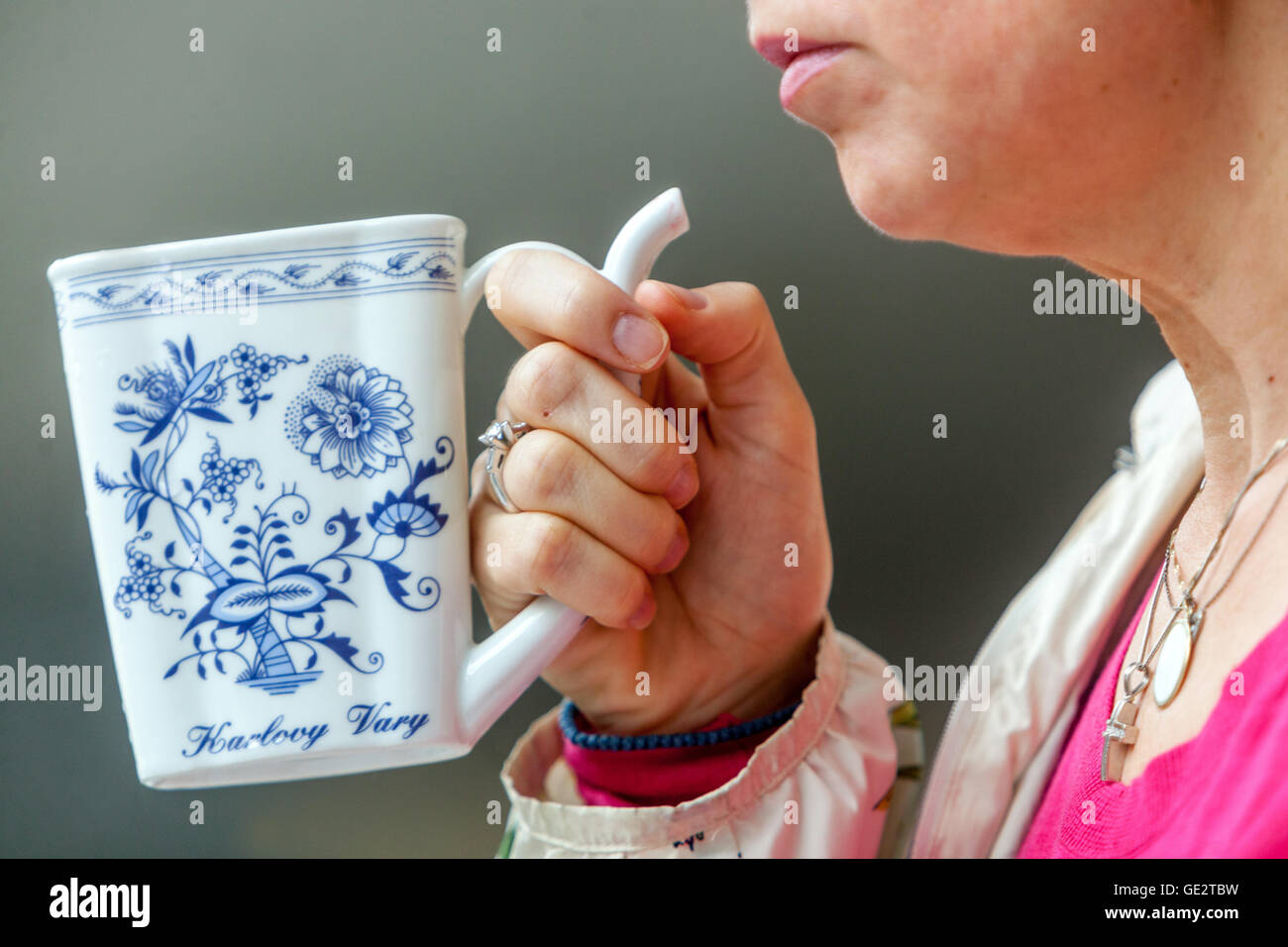 Woman drinking mineral water, Cup onion pattern porcelain Karlovy Vary Czech Republic Stock Photo