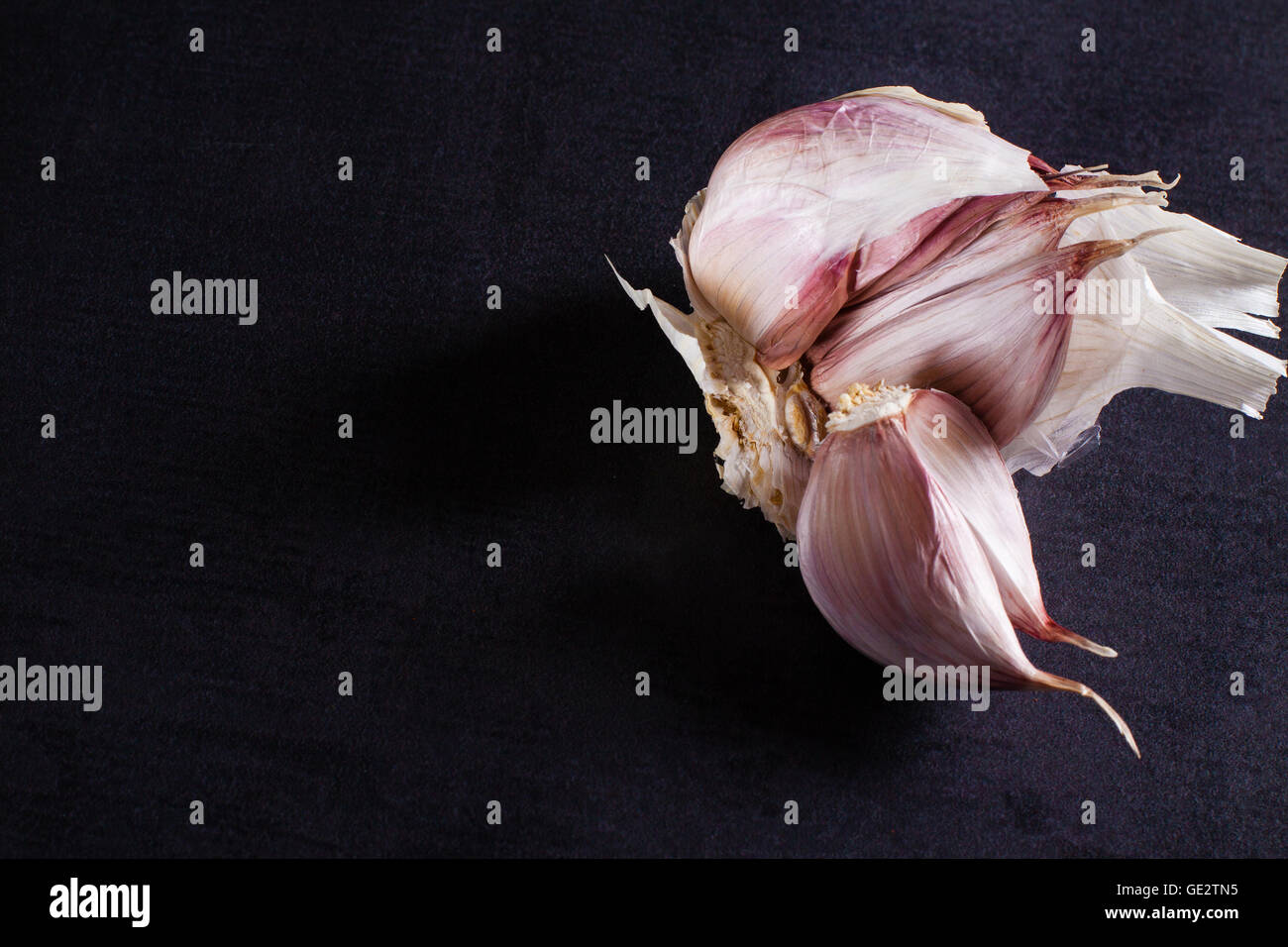 Fresh garlic on black background with copy space Stock Photo - Alamy