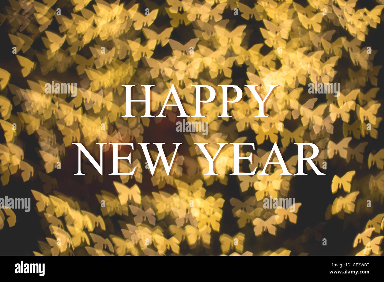 Christmas and New Year greeting card on golden butterfly light bokeh background Stock Photo