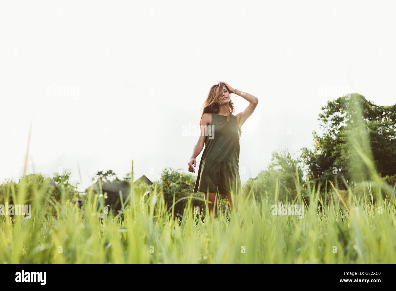 Portrait of beautiful young woman standing outdoors. Female fashion model posing outdoors. Stock Photo
