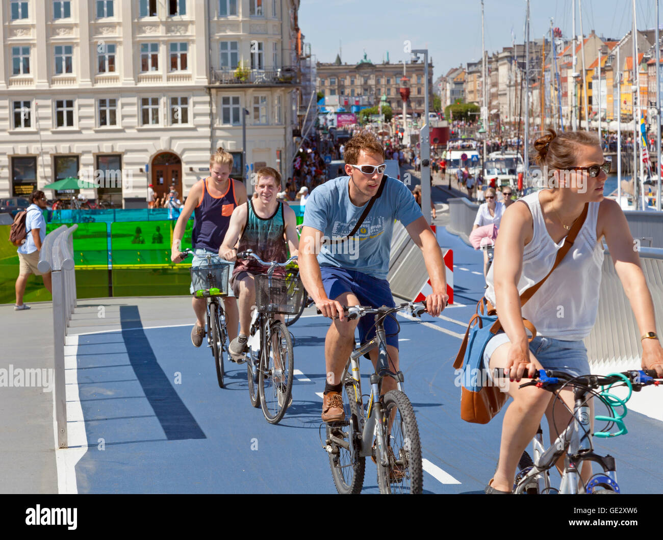 Cyclists or cyclers on the new pedestrian and cyclist bridge Inderhavnsbroen, Inner Harbour Bridge, connecting Nyhavn and Christianshavn in Copenhagen Stock Photo