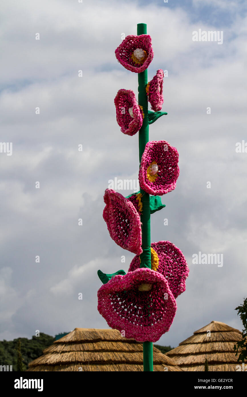 Knitted garden floral poppy art, knit flower patterns, artwork of big  flowers with oversize stalk & petals, colorful large tall knitted poppy  crochet, Remembrance Day crocheted poppies, reaching for the sky. Large -scale