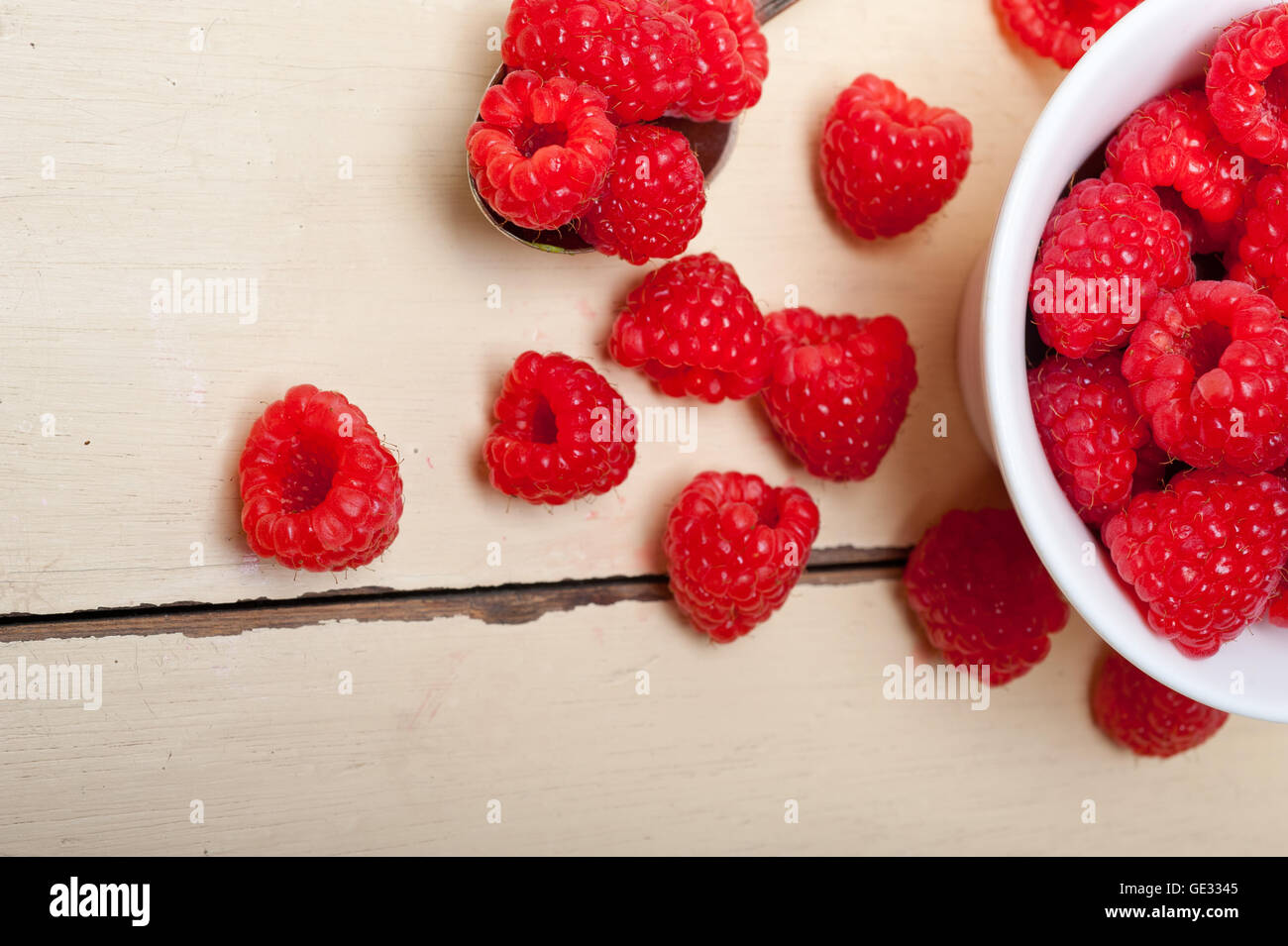 One Raspberry On A Table bunch of fresh raspberry on a bowl and white wood rustic table Stock ...