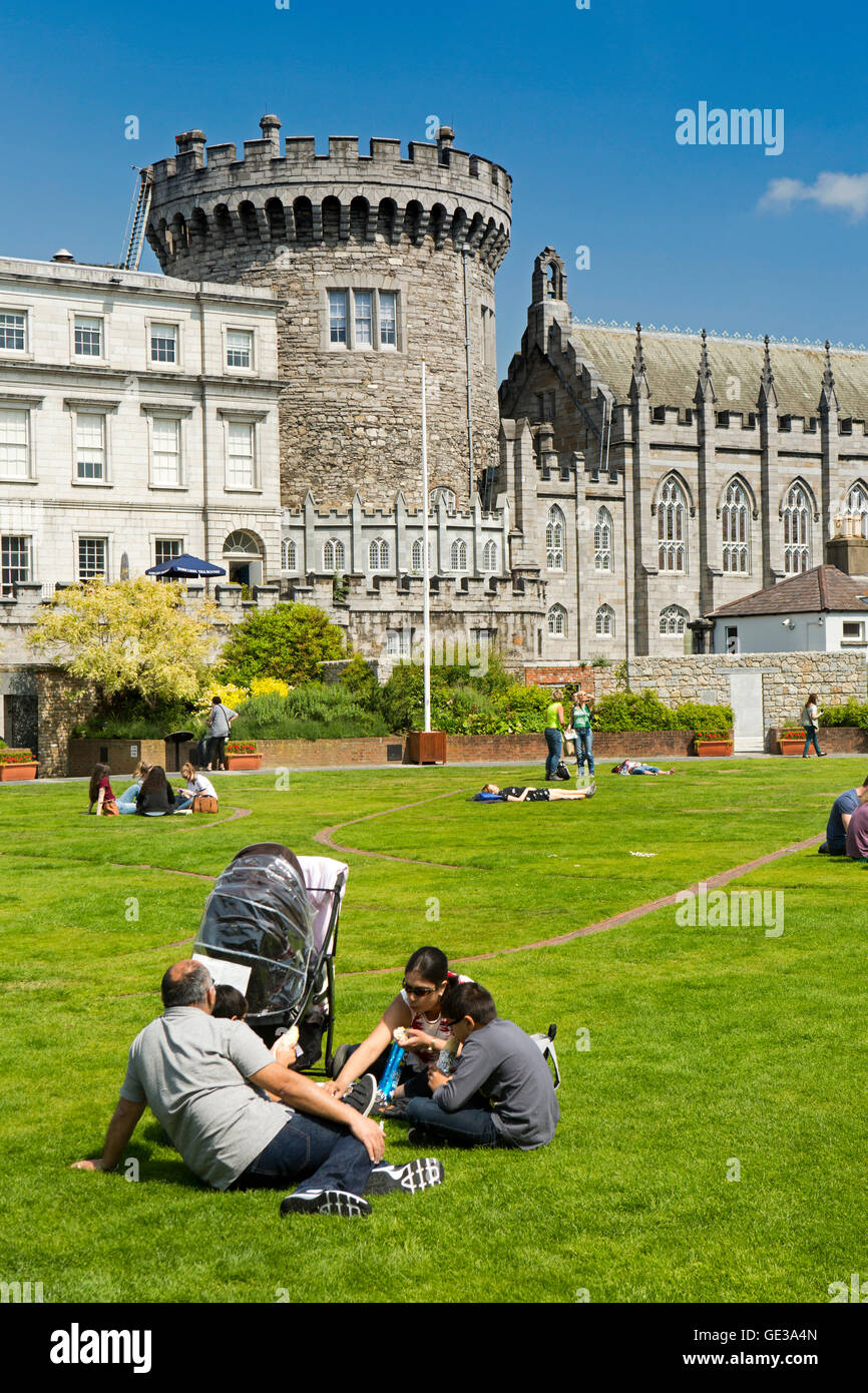 Ireland, Dublin, Dublin Castle, visitors on Dubhlinn Gardens lawn below Record Tower Stock Photo