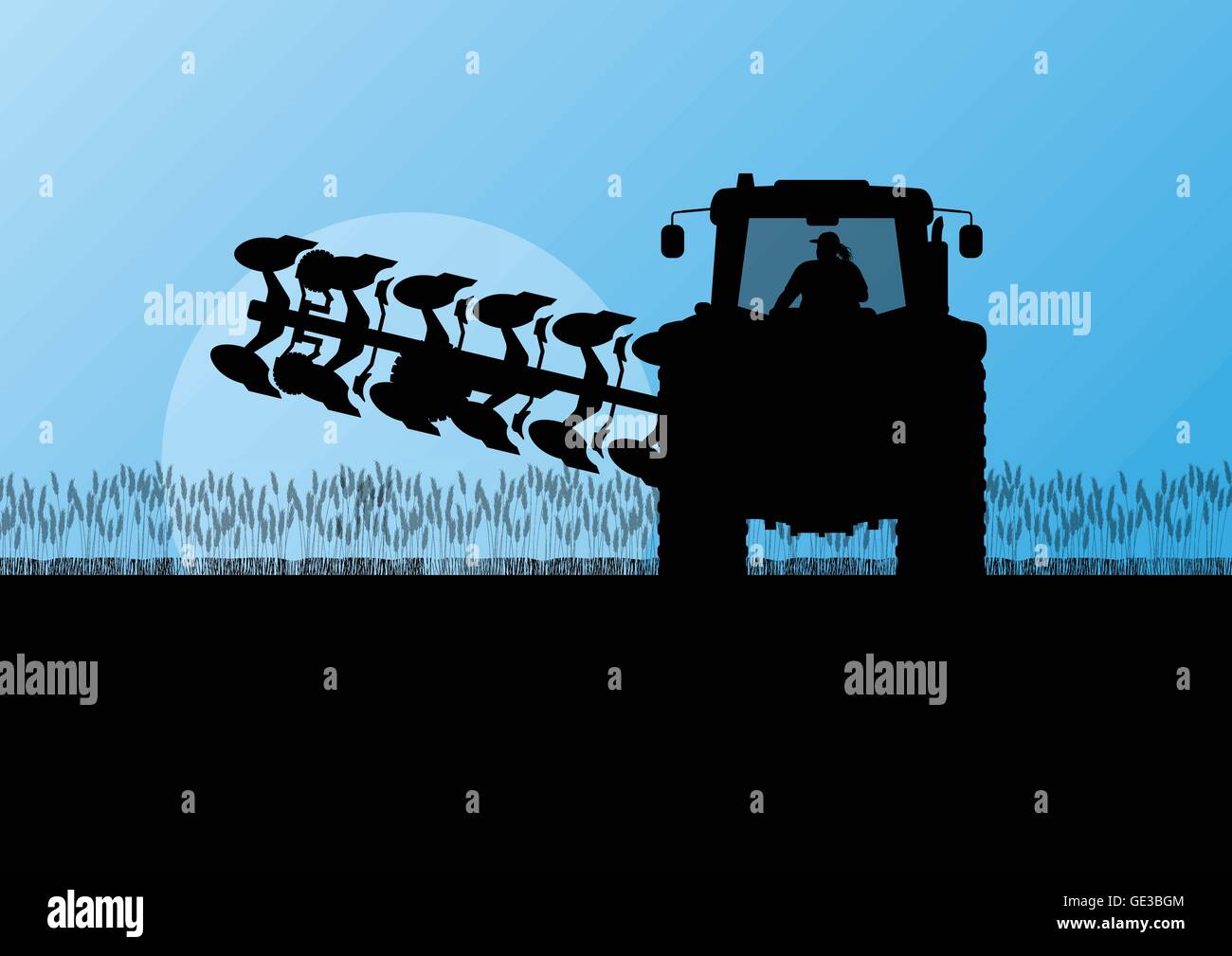 Agriculture tractor plowing the land in cultivated country grain field ...