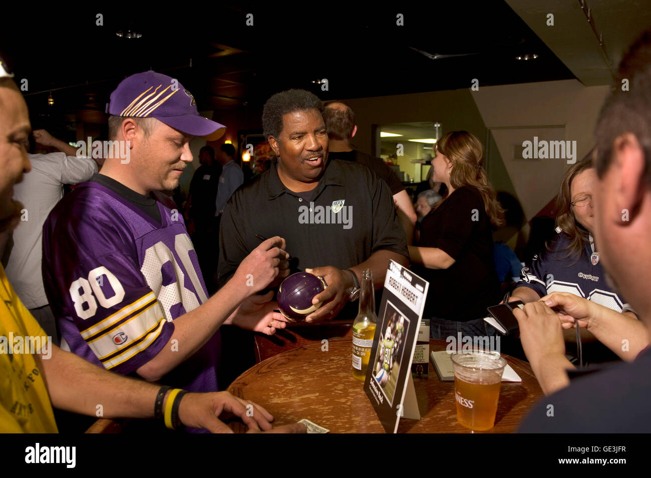 File. 22nd July, 2016. DENNIS GREEN, former head coach of the Vikings and Cardinals, has died at the age of 67, reportedly from cardiac arrest. Green became head coach of the Vikings in 1992, instantly leading the team to a playoff berth. In 1998, he coached the team to one of the best offensive performances in league history and finished 15-1. Green and the Vikings returned to the NFC title game in 2000. Pictured: Apr. 17, 2010 - Sacramento, California, U.S. - Dean Travis (cq), left, of south Sacramento, in Minnesota Vikings jersey gets an autograph on a small Vikings helmet from Dennis Gree Stock Photo