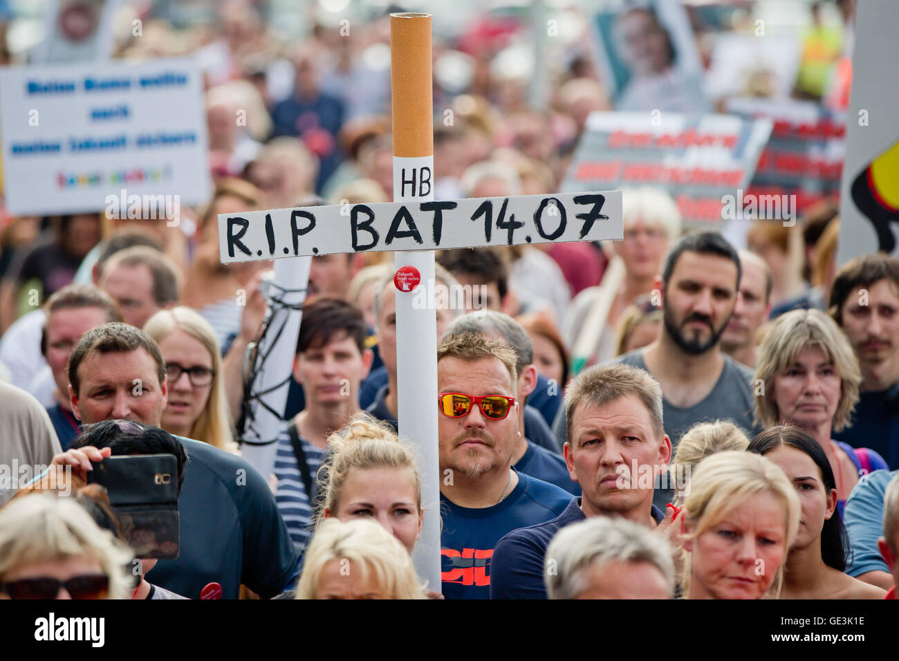 Employees of cigarette manufacturer British American Tobacco (BAT)  participating in a demonstration against the planned job cuts with a sign  reading 'R.I.P. BAT 14.07.' attached to an oversized cigarette in Bayreuth,  Germany,