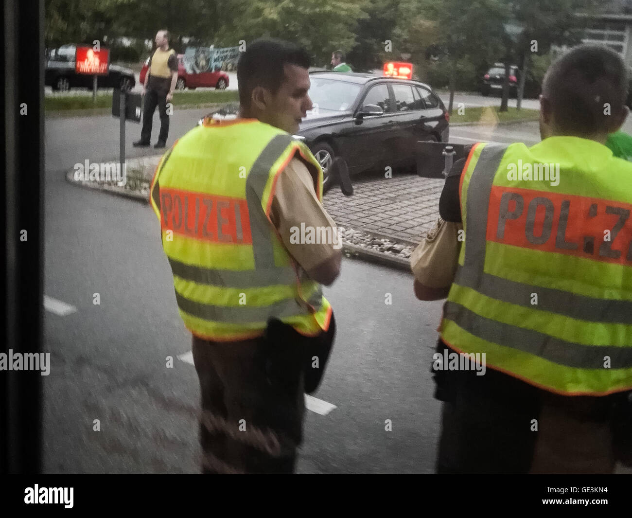 Munich. 22nd July, 2016. Photo taken by a mobile device shows police standing guard near the site of the shootout in Munich, Germany, on July 22, 2016. At least six people were killed in a shootout in the German city of Munich on Friday evening, German local media Focus Online reported. © Xinhua/Alamy Live News Stock Photo