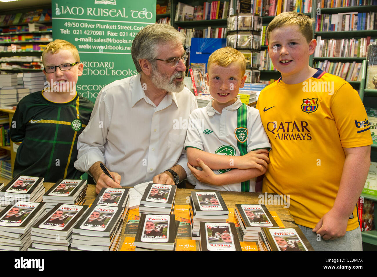 Cork, Ireland. 22nd July, 2016. Gerry Adams, the leader of Political Party Sinn Féin was in Liam Ruiseal's Bookshop in Oliver Plunkett Street, Cork, on Friday 22nd July, signing his new book - 'My Little Book of Tweets'. David, Luke and Seán Humphries-O'Mahony got their copy of the book signed by Mr Adams. Credit: Andy Gibson/Alamy Live News. Stock Photo