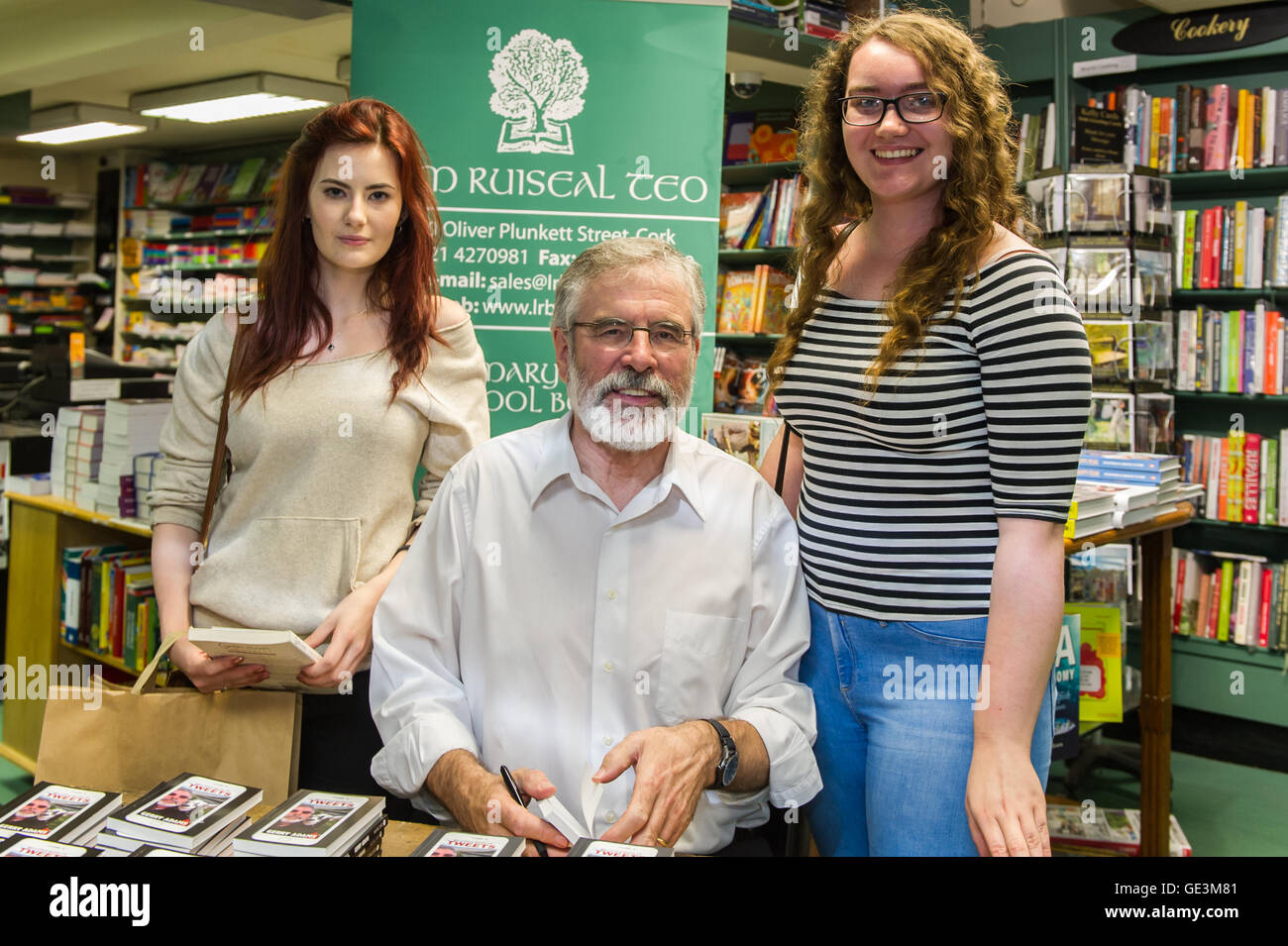 Cork, Ireland. 22nd July, 2016. Gerry Adams, the leader of Political Party Sinn Féin was in Liam Ruiseal's Bookshop in Oliver Plunkett Street, Cork, on Friday 22nd July, signing his new book - 'My Little Book of Tweets'. Sarah O'Sullivan from Beal Na Bláth and Aisling O'Leary from Ballincollig got their copies of the book signed by Mr Adams. Credit: Andy Gibson/Alamy Live News. Stock Photo