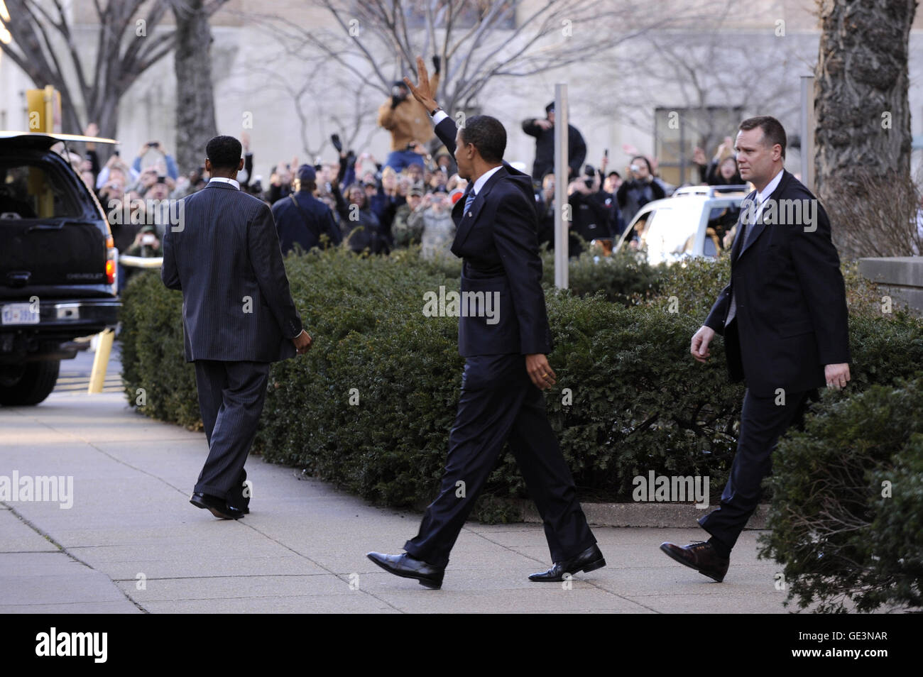 Washington, District of Columbia, USA. 8th Jan, 2009. Washington, DC - January 8, 2009 -- United States President-elect Barack Obama (C) waves to supporters as he leaves the Presidential Inaugural Committee Headquarters in Washington on Thursday, January 8, 2009. Credit: Kevin Dietsch - Pool via CNP © Kevin Dietsch/CNP/ZUMA Wire/Alamy Live News Stock Photo
