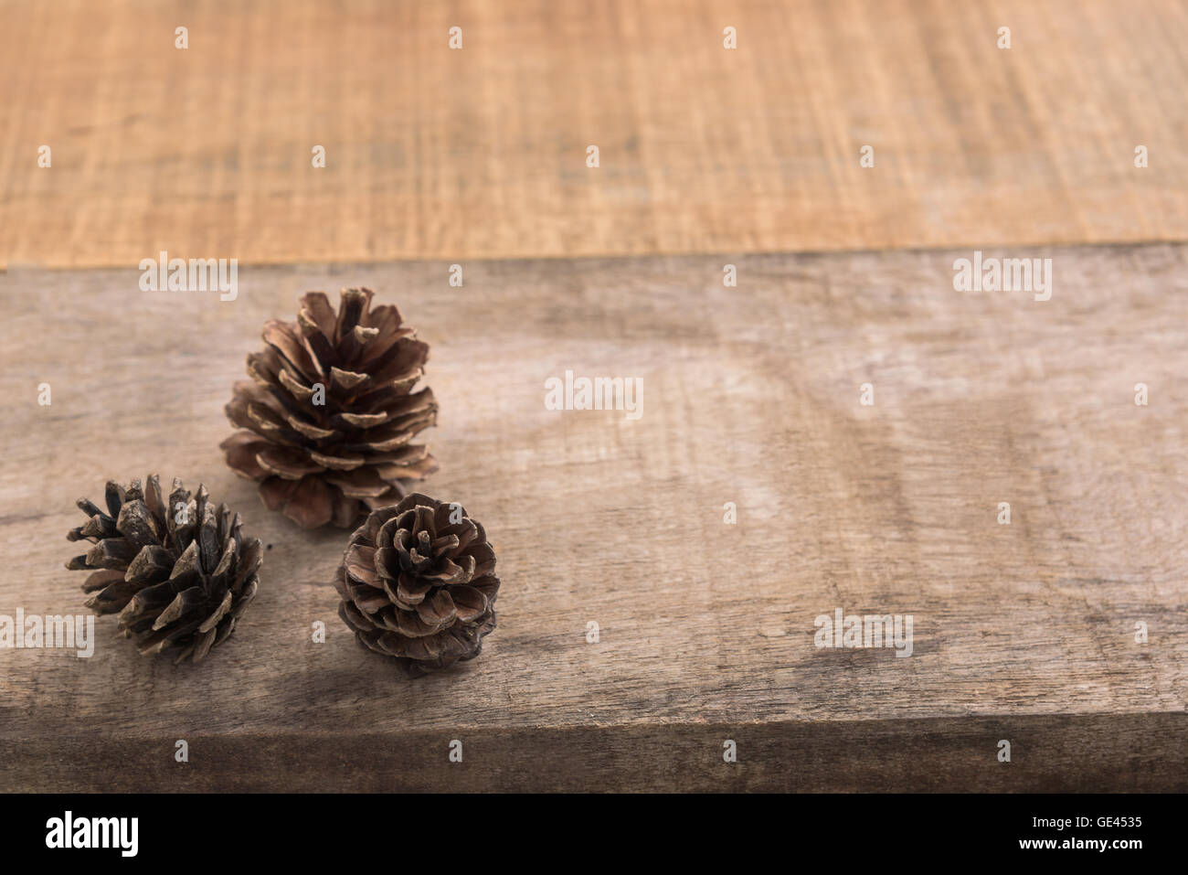 Pine cones on wooden background Stock Photo