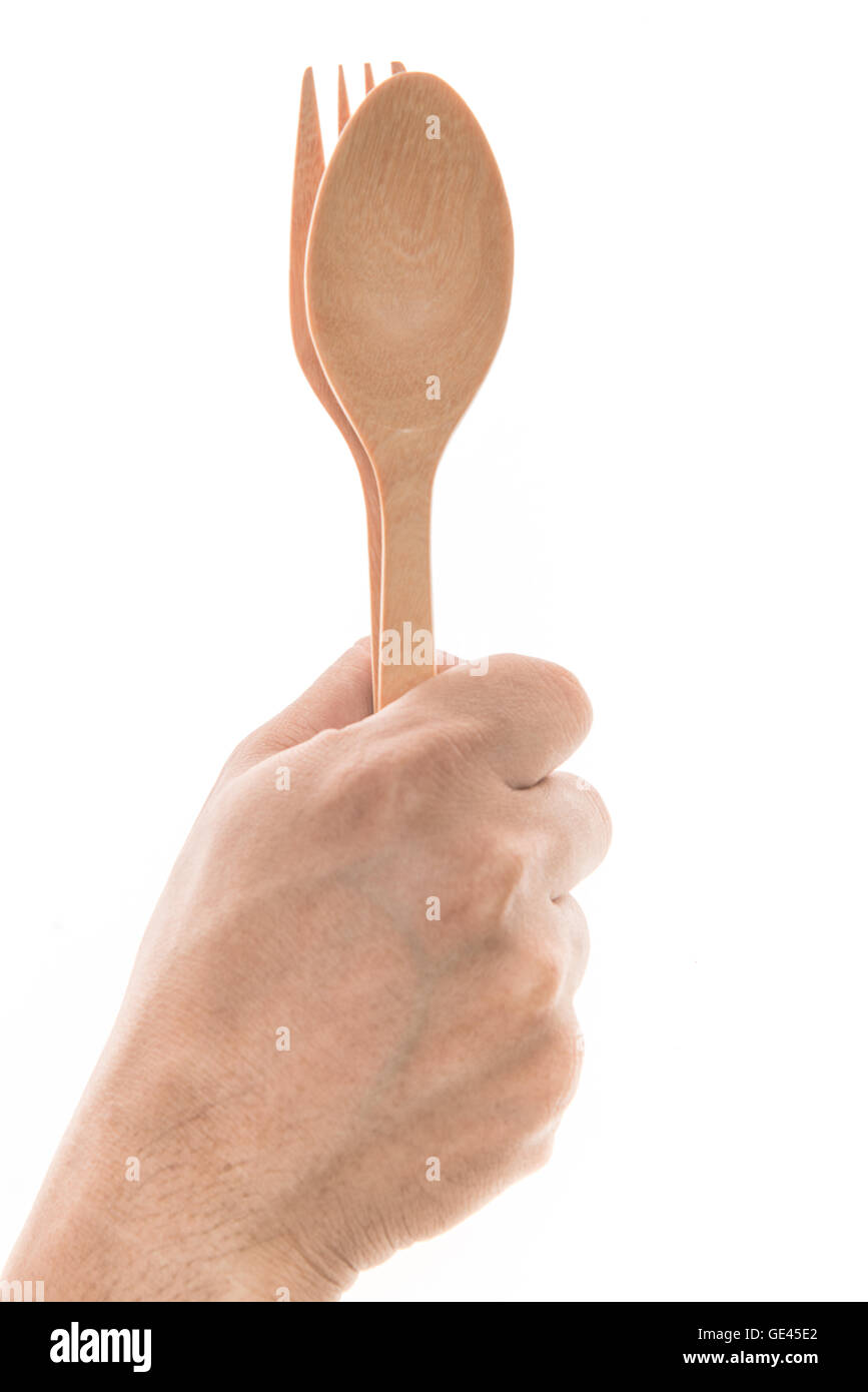 Men hand holding wooden spoon and fork Stock Photo Alamy