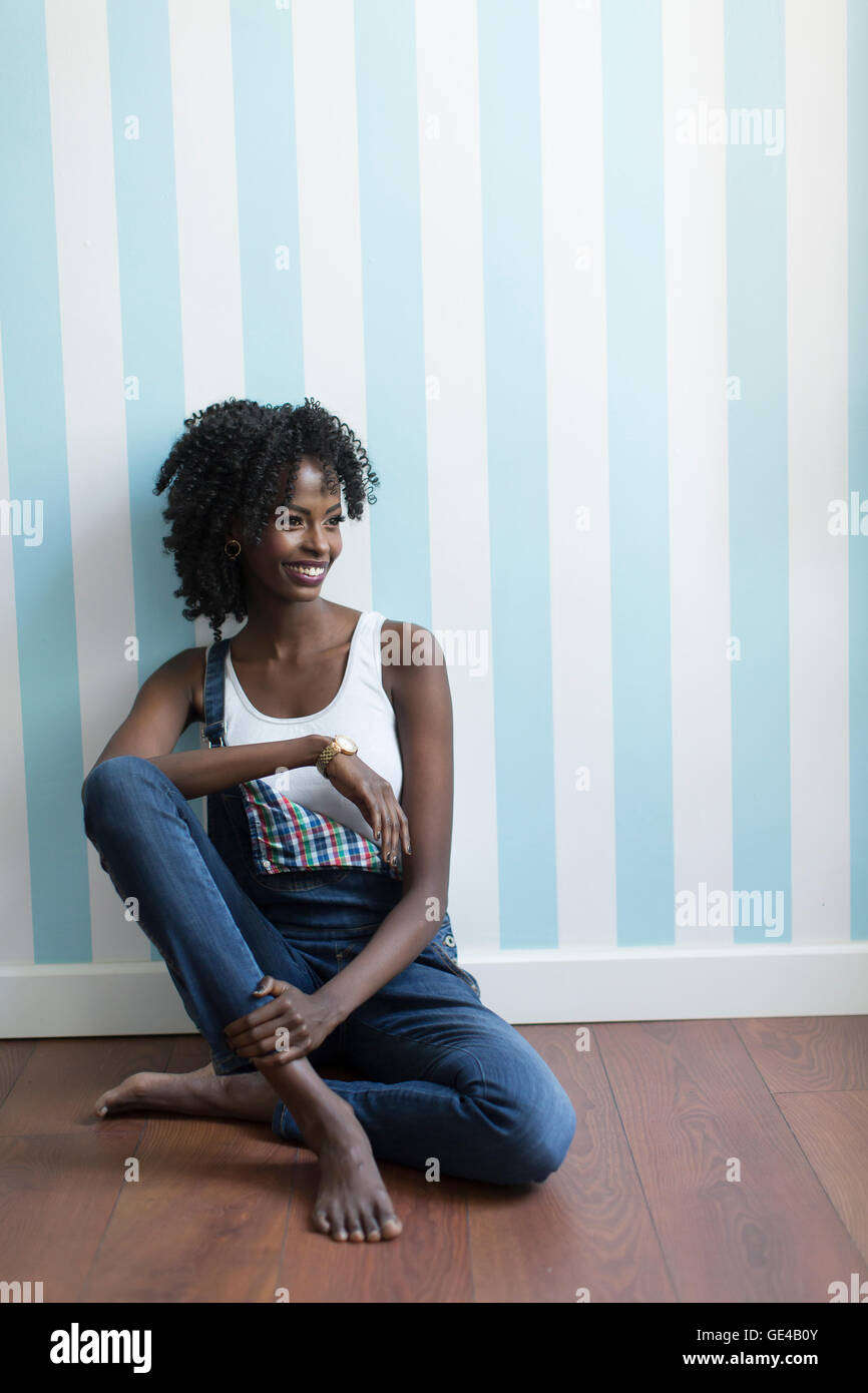 Young black woman in the room on the floor Stock Photo - Alamy