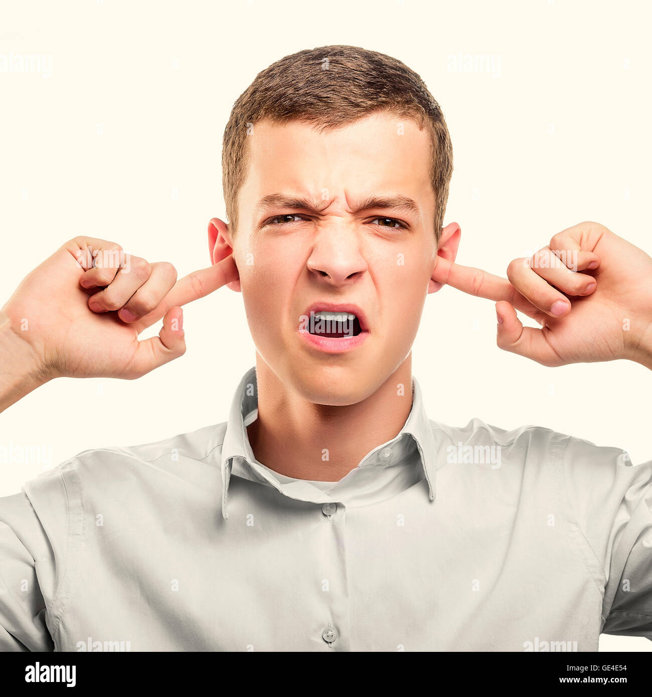 Angry businessman covering his ears. Toned photo Stock Photo Alamy