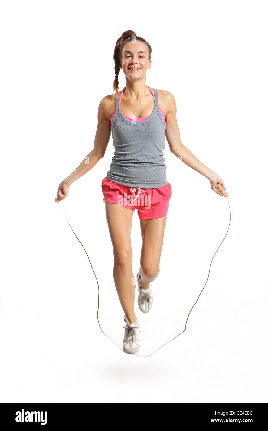 Shapely woman exercising with a jump rope. Stock Photo