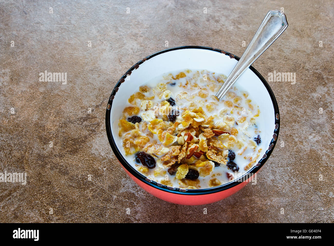 Bowl of fresh muesli with a mix of wheat, oats and bran with dried