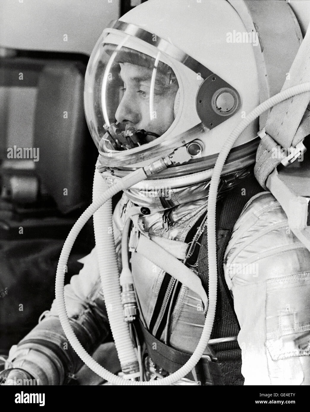 Profile of astronaut Alan Shepard in his silver pressure suit with the helmet visor closed as he prepares for his upcoming Mercury-Redstone 3 (MR-3) launch. On May 5th 1961, Alan B. Shepard Jr. became the first American to fly into space. His Freedom 7 Mercury capsule flew a suborbital trajectory lasting 15 minutes 22 seconds. His spacecraft splashed down in the Atlantic Ocean where he and Freedom 7 were recovered by helicopter and transported to the awaiting aircraft carrier U.S.S. Lake Champlain.  Image # : S61-02766  Date: May 5, 1961 Stock Photo