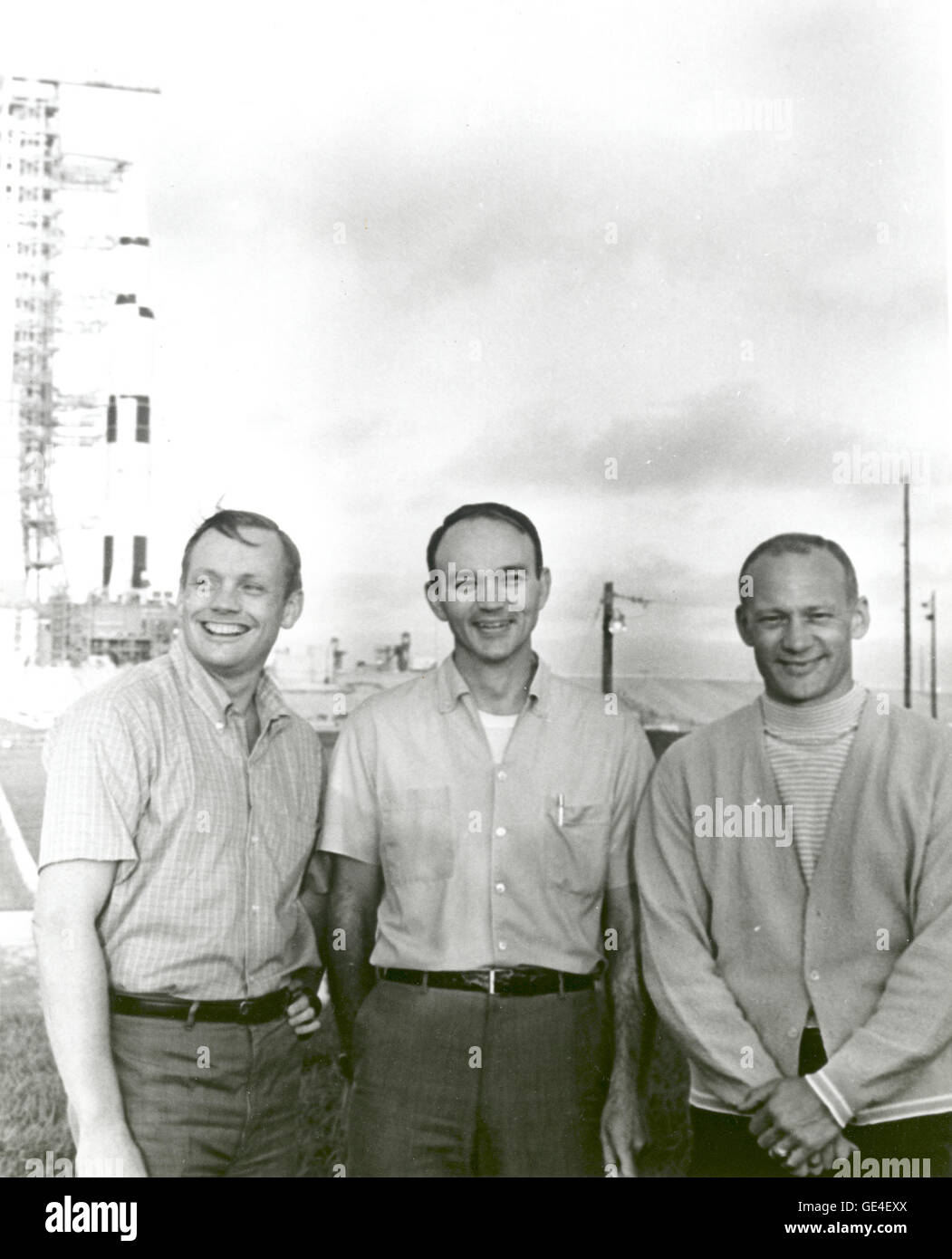 NASA's Apollo 11 flight crew, Neil A. Armstrong, commander; Michael Collins, command module pilot; and Buzz Aldrin, lunar module pilot stand near the Apollo/Saturn V space vehicle that would eventually carry them into space on July 16, 1969.  Image # : 69-H-913  Date: May 20, 1969 Stock Photo