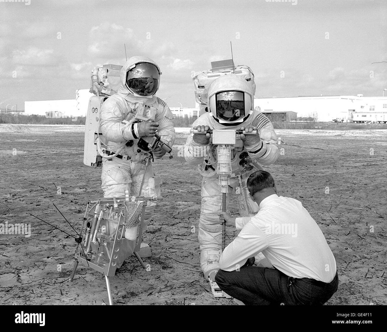(January 28, 1970) The two members of the Apollo 13 crew who planned to land on the Moon's Fra Mauro region in the lunar module underwent a walk-through of the extravehicular activity timeline. Fred W. haise, Jr., Lunar Module Pilot, tries out a motorized core sampler, right, while James A. Lovell, Jr., the Apollo 13 Commander, looks on at left.  Image # : 70P-0046 Stock Photo