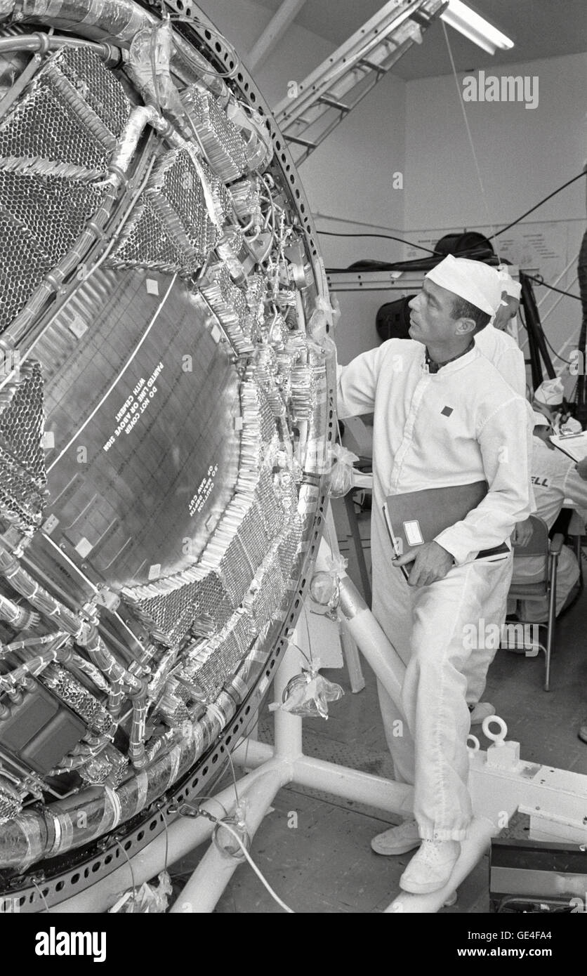 Inside Hangar S at the White Room Facility at Cape Canaveral, Florida, Mercury astronaut M. Scott Carpenter examines the honeycomb protective material on the main pressure bulkhead of his Mercury capsule nicknamed &quot;Aurora 7.&quot;   Image # : S62-01420 Date: March 6, 1962 Stock Photo