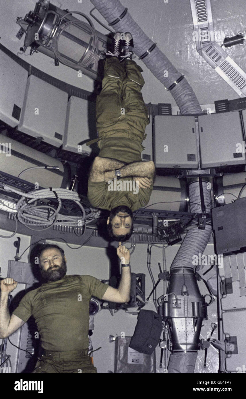 Astronaut Gerald P. Carr, Commander for the Skylab 4 mission, jokingly demonstrates weight training in zero-gravity as he balances astronaut William R. Pogue, pilot, upside down on his finger.  Image # : SL4-150-5080 Date: February 1, 1974 Stock Photo