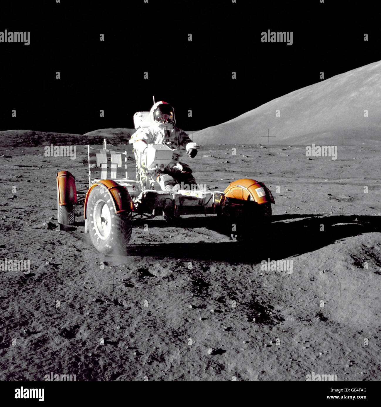 Astronaut Eugene A. Cernan, Apollo 17 mission commander, makes a short checkout of the Lunar Roving Vehicle during the early part of the first Apollo 17 extravehicular activity (EVA-1) at the Taurus-Littrow landing site. This view of the &quot;stripped down&quot; Rover is prior to loadup. This photograph was taken by Geologist-Astronaut Harrison H. Schmitt, Lunar Module pilot. The mountain in the right background is the East end of South Massif.  Image # : AS17-147-22526  December 11, 1972 Stock Photo