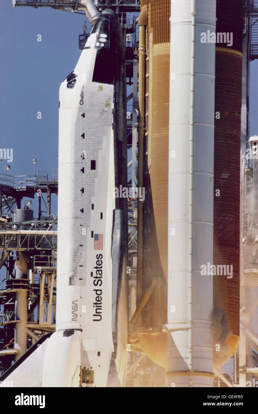 Close-up view of the liftoff of the Shuttle Challenger on mission STS-51L taken from camera site 39B-2/T3. From this camera position, a cloud of grey-brown smoke can be seen on the right side of the Solid Rocket Booster (SRB) on a line directly across from the letter &quot;U&quot; in United States. This was the first visible sign that an SRB joint breach may have occured. On January 28, 1986 frigid overnight temperatures caused normally pliable rubber O-ring seals and putty that are designed to seal and establish joint integrity between the Solid Rocket Booster (SRB) joint segments, to become  Stock Photo