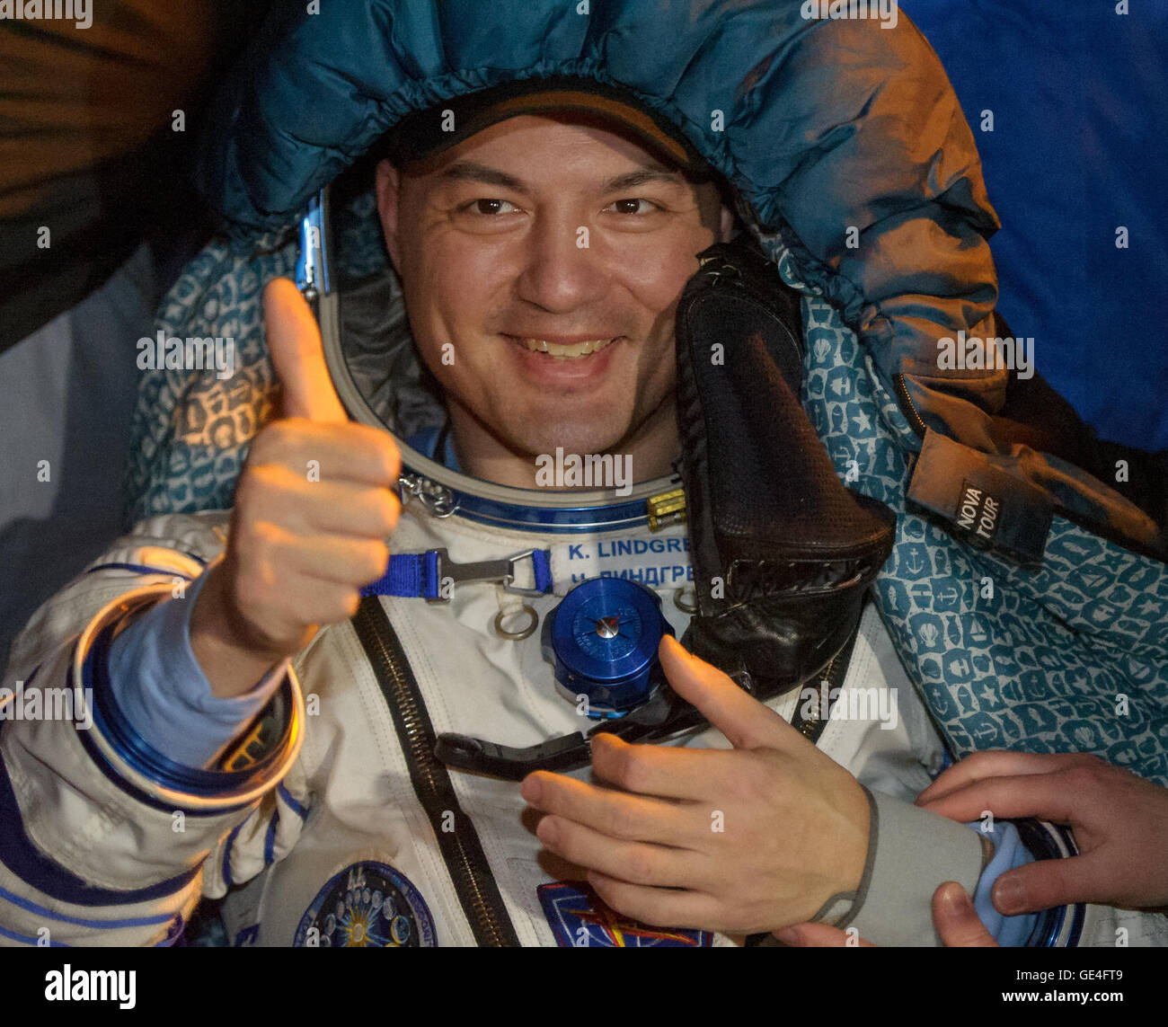 NASA Astronaut Kjell Lindgren rests in a chair just minutes after he and Kimya Yui of the Japan Aerospace Exploration Agency (JAXA) and Oleg Kononenko of the Russian Federal Space Agency (Roscosmos) landed in their Soyuz TMA-17M spacecraft  in a remote area near the town of Zhezkazgan, Kazakhstan on Friday, December 11, 2015. Kononenko, Lindgren, and Yui returned after 141 days in space where they served as members of the Expedition 44 and 45 crews onboard the International Space Station. Photo Credit: (NASA/GCTC/Andrey Shelepin)  Image #: Date: December 11, 2015 Stock Photo