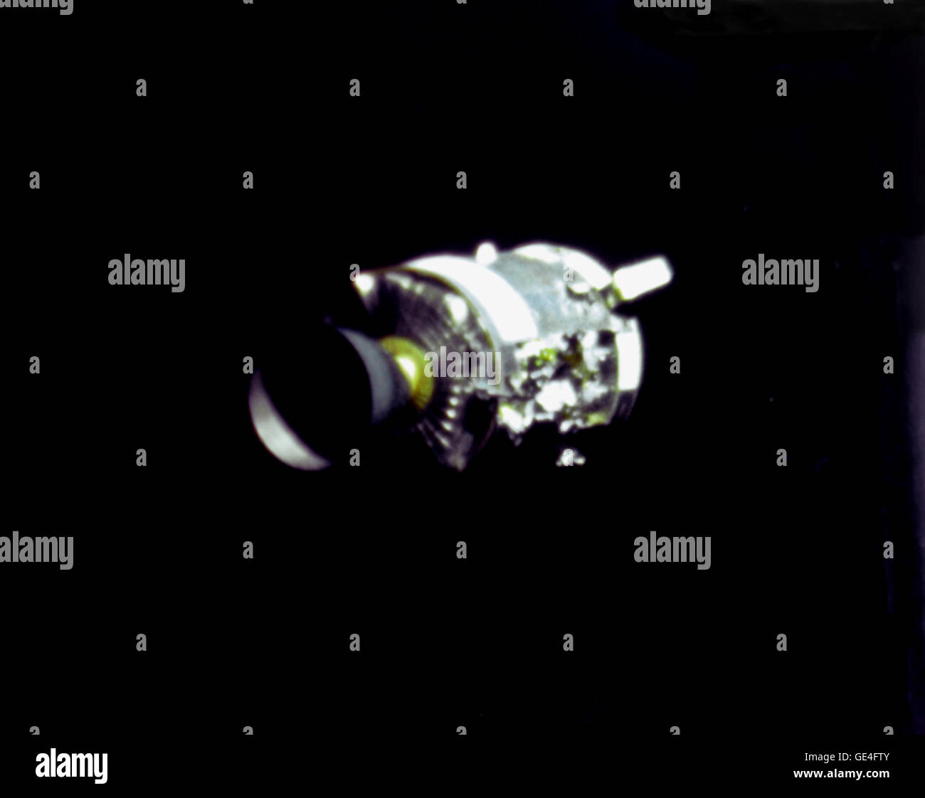This view of the damaged Apollo 13 Service Module (SM) was photographed from the Lunar Module/Command Module following SM jettisoning. As seen here, an entire SM panel was blown away by the apparent explosion of oxygen tank number two located in Sector 4 of the SM. Two of the three fuel cells are visible just forward (above) the heavily damaged area. Three fuel cells, two oxygen tanks, and two hydrogen tanks are located in Sector 4. The damaged area is located above the S-Band high gain antenna. Nearest the camera is the Service Propulsion System (SPS) engine and nozzle. The damage to the SM c Stock Photo