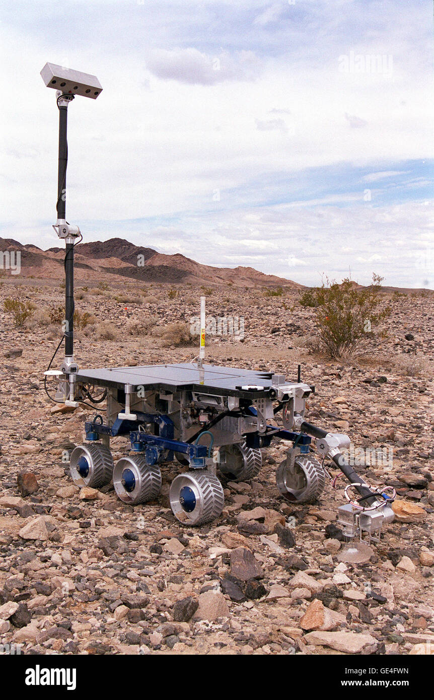 The Field Integrated Design and Operations (FIDO) rover extends the large mast that carries its panoramic camera. The FIDO is being used in ongoing NASA field tests to simulate driving conditions on Mars. FIDO is controlled from the mission control room at JPL's Planetary Robotics Laboratory in Pasadena. FIDO uses a robot arm to manipulate science instruments and it has a new mini-corer or drill to extract and cache rock samples. Several camera systems onboard allow the rover to collect science and navigation images by remote-control. The rover is about the size of a coffee table and weighs as Stock Photo