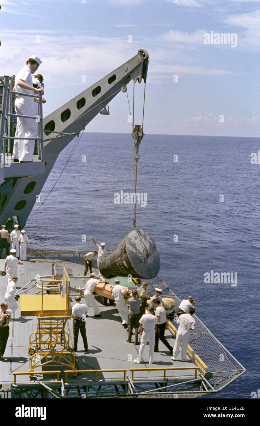 The Gemini 5 spacecraft is brought aboard the recovery ship, U.S.S. Lake Champlain after a successful splashdown at the end of its mission.  Image # : S65-46630 Date: August 29, 1965 Stock Photo