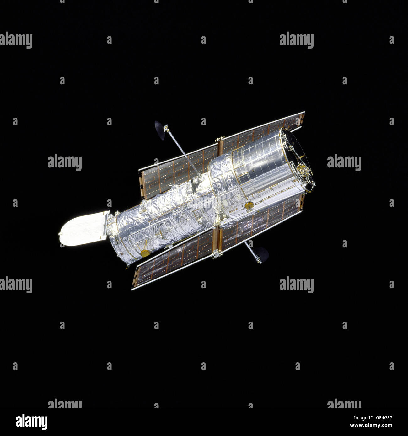 Orbiter Discovery performs a flyaround of the Hubble Space Telescope (HST) after redeployment on the second servicing mission designated HST SM-02. The silvery telescope, with its aperture door open, is sharply contrasted by the velvety blackness of space.  Image # : STS082-746-040 Stock Photo