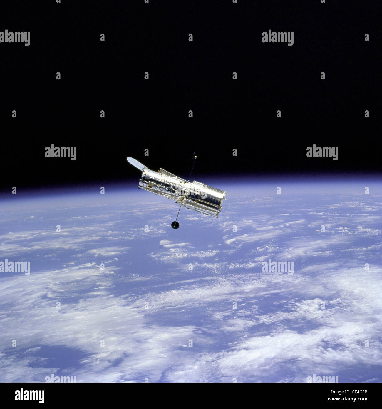 Flyaround of the Hubble Space Telescope (HST) after deployment on this second servicing mission (HST SM-02). Note the telescope's open aperature door.   Image # : STS082-746-059 Stock Photo
