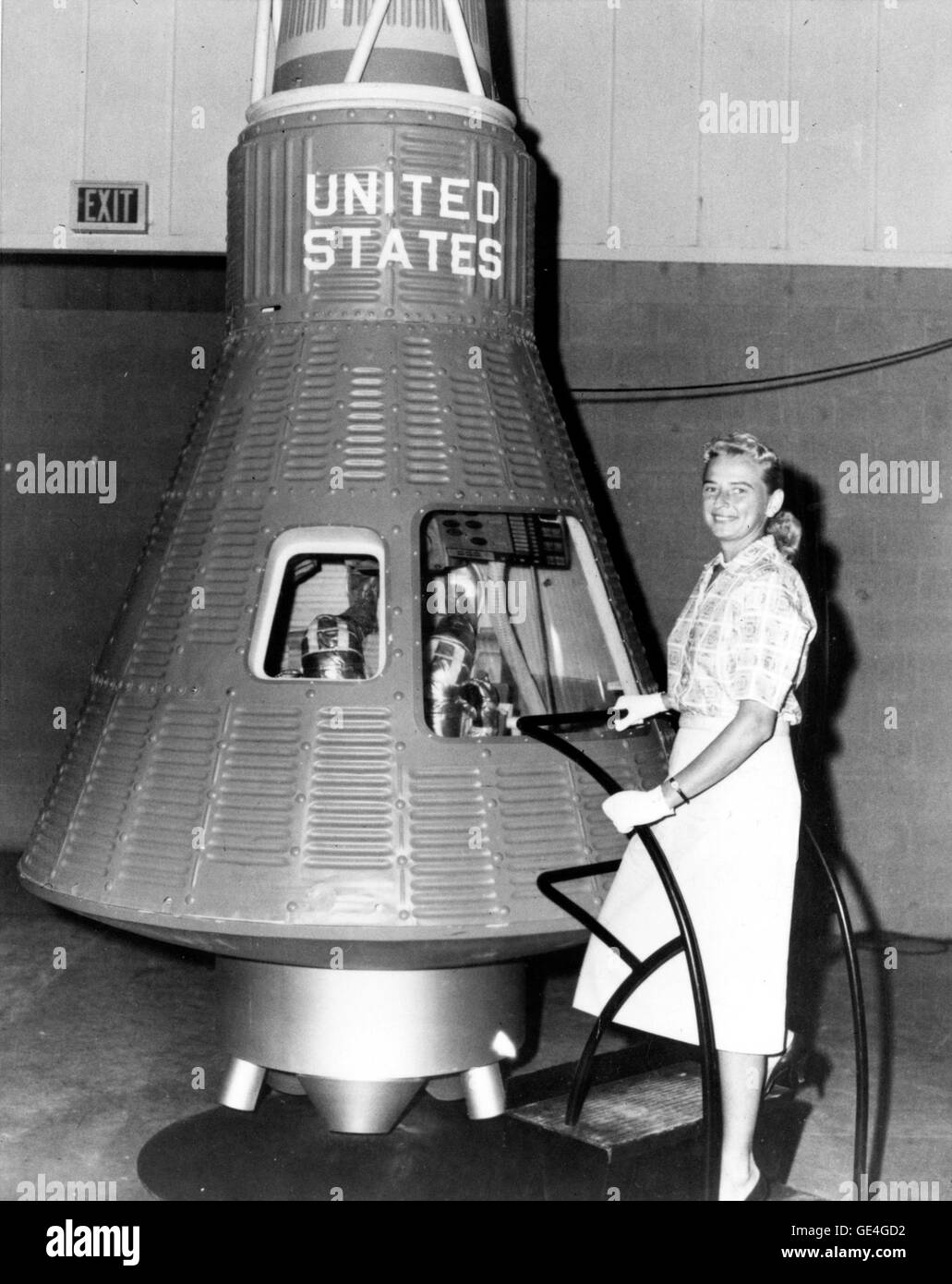 Jerrie Cobb poses next to a Mercury spaceship capsule. Although she never flew in space, Cobb, along with twenty-four other women, underwent physical tests similar to those taken by the Mercury astronauts with the belief that she might become an astronaut trainee. All the women who participated in the program, known as First Lady Astronaut Trainees, were skilled pilots. Dr. Randy Lovelace, a NASA scientist who had conducted the official Mercury program physicals, administered the tests at his private clinic without official NASA sanction. Cobb passed all the training exercises, ranking in the  Stock Photo