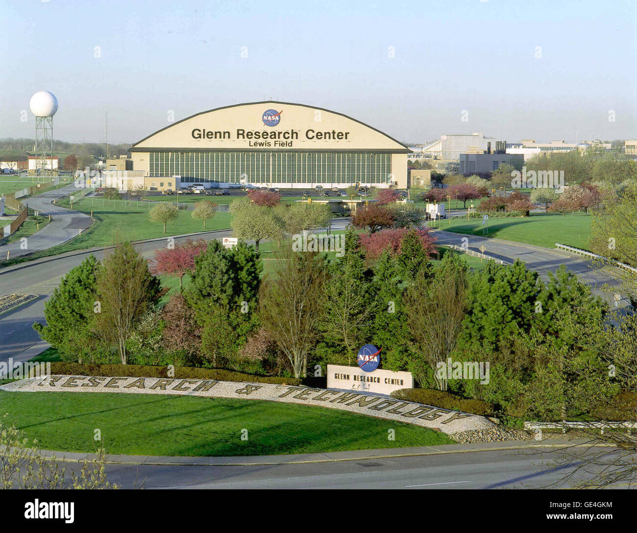 View of the Hangar and Main Gate at NASA's John H. Glenn Research Center, Cleveland, Ohio. Formerly known as the Airplane Engine Research Laboratory (AERL) under the National Advisory Committee for Aeronautics (NACA),and then renamed the Lewis Research Center, for George W. Lewis, NACA Director of Aeronautical Research. It was renamed the John H. Glenn Research Center at Lewis Field in 1999. Here aircraft engines and spacecraft propulsion systems are developed and tested.  Image # : c1999-892 Stock Photo